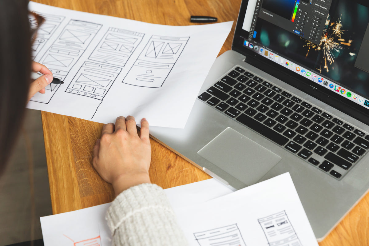 female designer reviewing wireframes